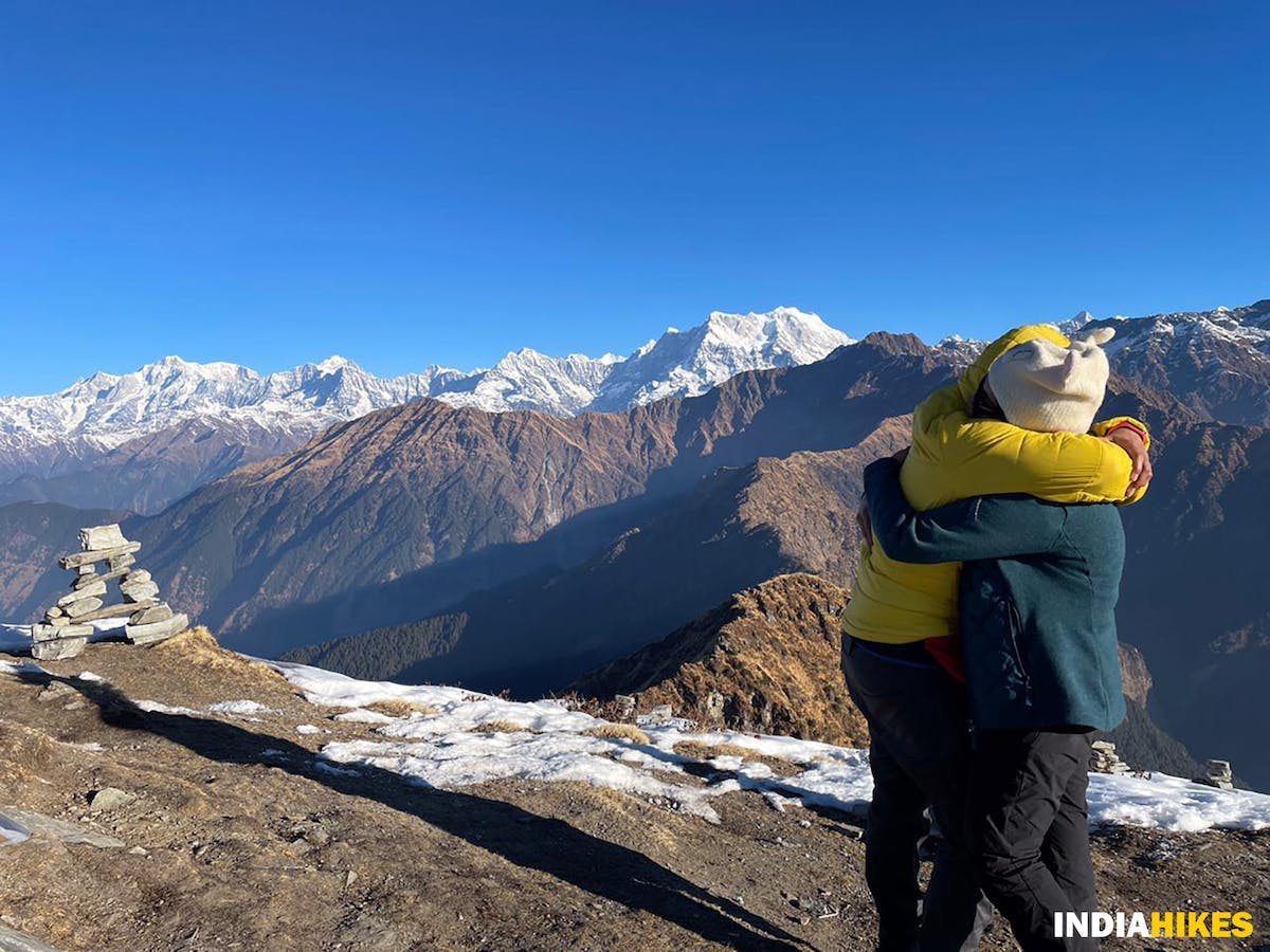 Two trekkers hugging each other on top of the Deoriatal Chandrashila summit 