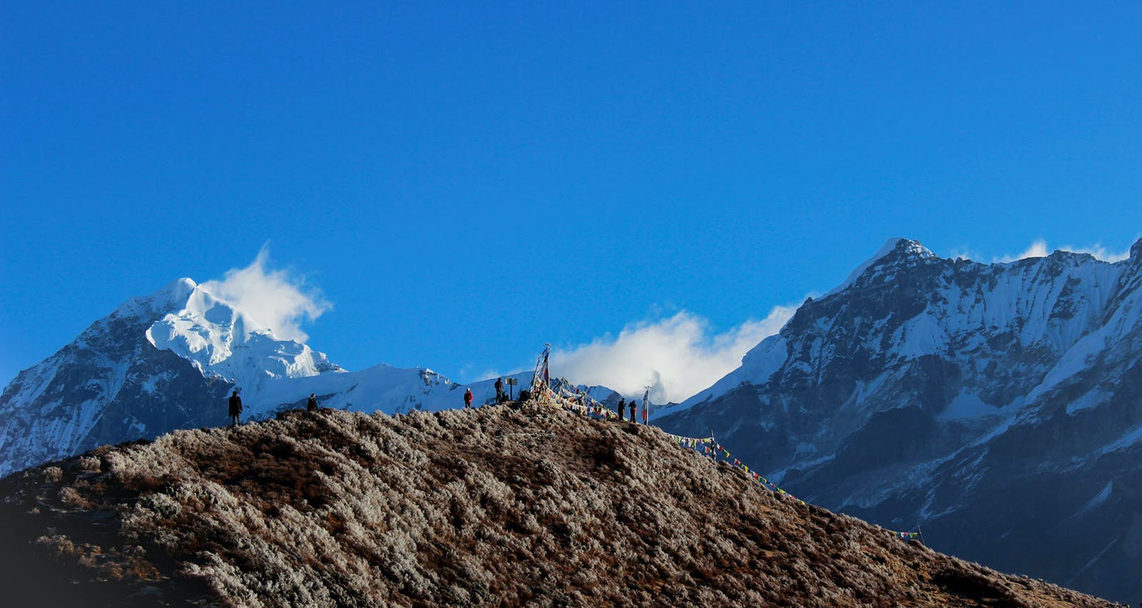 Trekkers standing on viewpoint 2 amidst the backdrop of Mt Kanchenjunga